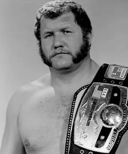 Harley Race with a championship belt in an archival black-and-white photograph